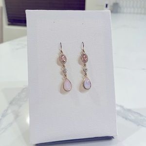 Gold dangling earrings with pink jewels